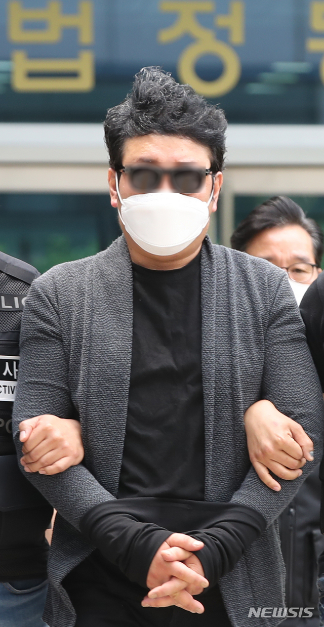 [서울=뉴시스] 조수정 기자 = 서울 우이동 한 아파트 경비원 폭행 혐의를 받는 입주민 심 모씨가 22일 오전 구속 전 피의자심문(영장실질심사)를 받은 뒤 서울 도봉동 서울북부지방법원을 나서 경찰 호송차량으로 향하고 있다. 2020.05.22.&nbsp; chocrystal@newsis.com