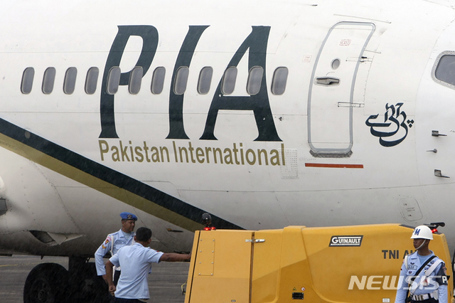 FILE - In this March 7, 2011, file photo, a Pakistan International Airlines passenger jet is parked on the tarmac at a military base in Makassar, Indonesia. A passenger plane belonging to state-run airline Pakistani International Airlines crashed Friday, May 22, 2020, near the southern port city of Karachi, according to Abdul Sattar Kokhar, spokesman for the country&#039;s civil aviation authority. (AP Photo/File)