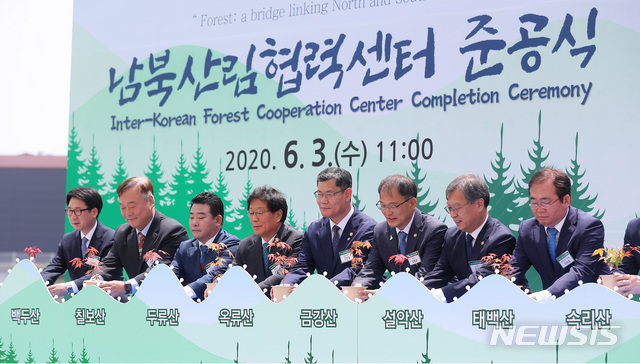 [파주=뉴시스]전신 기자 = 김연철 통일부 장관이 3일 경기도 파주 남북산림협력센터에서 열린 준공식에서 준공 축하 퍼포먼스를 하고 있다. 왼쪽부터 최종환 파주시장, 이재강 경기도 평화부시장, 더불어민주당 박정, 윤후덕 의원, 김 장관, 박종호 산림청장, 김거성 시민사회수석. 2020.06.03. photo1006@newsis.com