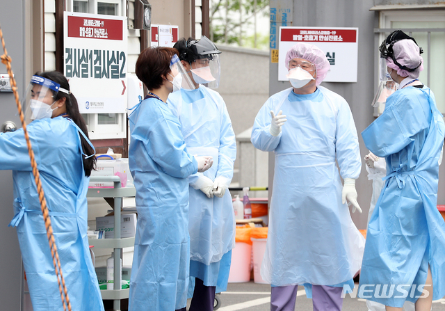 [인천=뉴시스] 이종철 기자 = 신종 코로나바이러스 감염증(코로나19)의 집단감염이 확산되고 무더운 날씨가 계속되는 가운데 12일 오후 인천시 부평구 가톨릭대학교 인천성모병원 선별진료소에서 의료진들이 레벨D 방호복보다 얇고 통풍이 잘 되는 수술용 1회용 가운을 착용하고 의견을 나누고 있다. 2020.06.12.&nbsp; jc4321@newsis.com