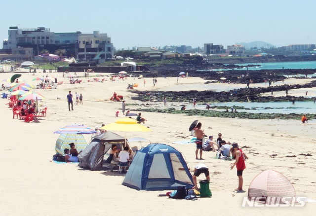 [제주=뉴시스] 양영전 기자 = 제주도 내 11곳 해수욕장이 정식 개장한 1일 제주시 곽지해수욕장을 찾은 피서객들이 해수욕을 즐기고 있다. 이날 주로 가족 단위 관광객과 젊은 연인 관광객이 해수욕장을 찾아 더위를 식혔다. 2020.07.01 0jeoni@newsis.com 
