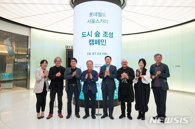 [서울=뉴시스]24일 롯데월드타워 서울스카이에서 열린 기부금 전달식에서 기념촬영하는 롯데월드와 환경재단 관계자들 