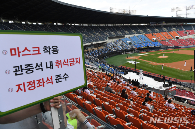 [서울=뉴시스] 고승민 기자 = 중앙재난안전대책본부의 프로스포츠 관중 입장 재개 발표에 따라 프로야구 경기부터 관중석의 10% 규모로 입장을 시작한 26일 서울 잠실야구장에서 열린 LG트윈스 대 두산베어스 경기를 찾은 시민들이 거리를 두어 앉아 있다. 2020.07.26. photo@newsis.com