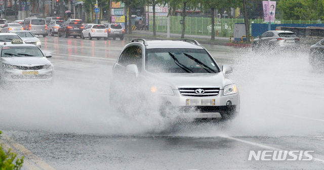 [전주=뉴시스] 김얼 기자 = 장마가 이어지고 있는 지난 28일 전북 전주시 백제교 인근에서 운전자들이 쏟아져 내린 폭우로 빗물에 잠긴 차도를 지나고 있다. 2020.07.28.pmkeul@newsis.com