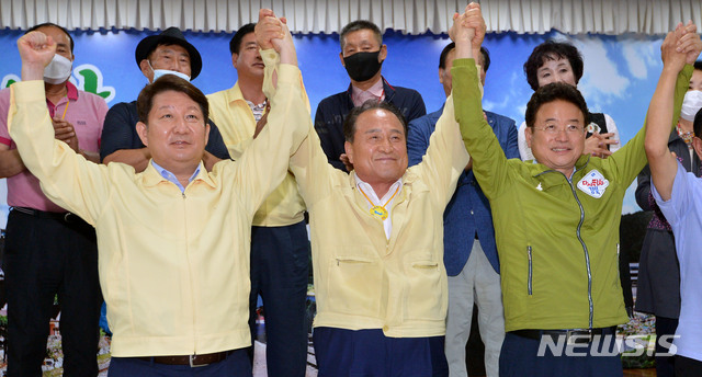 [군위=뉴시스] 이무열 기자 = 권영진(왼쪽부터) 대구시장과 김영만 군위군수, 이철우 경북지사가 30일 오후 경북 군위군청 대회의실에서 대구경북 통합신공항 이전지를 공동후보지로 신청할 것을 조건부 합의 후 손을 맞잡고 있다. 2020.07.30.lmy@newsis.com