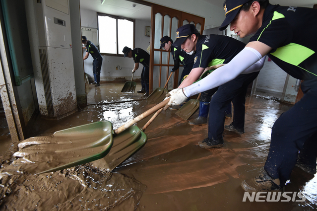 [이천=뉴시스] 김종택기자 = 4일 오후 집중호우로 침수 피해를 입은 경기 이천시 율면 산양1리 마을회관에서 경기남부청 소속 경찰들이 복구작업을 하고 있다. 2020.08.04.semail3778@naver.com