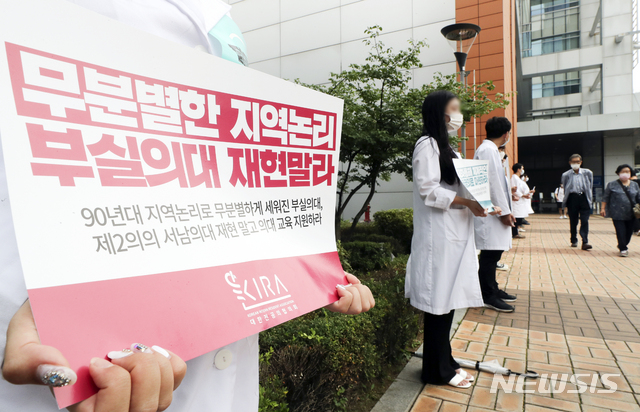 [서울=뉴시스] 최진석 기자 = 정부의 의과대학 정원 확대에 반발해 전공의들이 집단 휴진에 돌입한 7일 서울 서초구 성모병원 앞에서 정부 정책에 반대하는 피켓을 들고 있다. 2020.08.07. myjs@newsis.com