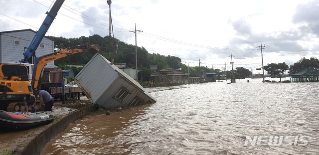 [나주=뉴시스]이창우 기자 = 9일 영산강 대홍수로 침수된 전남 나주시 다시면 죽산 마을에서 주민들이 중장비를 동원해 컨테이너 가건물을 옮기고 있다. (사진=독자 제공) 2020.08.09.&nbsp; photo@newsis.com 