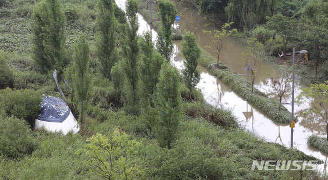 [서울=뉴시스] 최진석 기자 = 장맛비가 이어지고 있는 지난 10일 서울 동작대교에서 바라본 한강공원 산책로가 잠수돼 있는 옆으로 배가 뒤집어져 있다. 2020.08.10.myjs@newsis.com