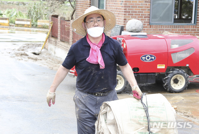 [서울=뉴시스] 장세영 기자 = 주호영 미래통합당 원내대표가 11일 전남 구례군 문척면 구성마을에서 침수 피해 폐기물을 정리하고 있다. (사진=미래통합당 제공) 2020.08.11. photo@newsis.com