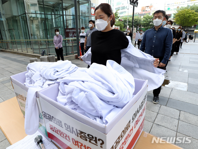 [서울=뉴시스] 이윤청 기자 = 대한전공의협의회 주도 '젊은의사 단체행동' 관계자들이 지난 23일 서울 광진구 건국대병원에서 의대 정원 확대 재논의 등을 촉구하며 의사 가운을 벗고 있다. 2020.08.23. radiohead@newsis.com