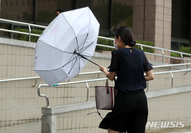 [과천=뉴시스] 고승민 기자 = 태풍 '바비'의 영향으로 비와 세찬 바람이 부는 날씨를 보인 지난 27일 과천 법무부 청사에서 출근하던 한 직원의 우산이 바람에 뒤집어지고 있다. 2020.08.27.kkssmm99@newsis.com