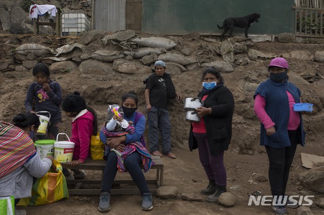 [리마=AP/뉴시스]21일(현지시간) 페루 수도 리마 외곽의 누에바 에스페란자에 있는 한 무료 급식소 주변에서 주민들이 음식 배급을 기다리고 있다. 페루의 코로나19 누적 확진자 수는 76만8895명, 사망자는 3만1369명으로 집계됐다. 2020.09.22.