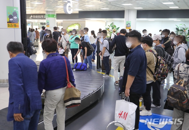 [제주=뉴시스]우장호 기자 = 제주공항 국내선입국장에서 관광객들이 신종 코로나바이러스 감염증(코로나19) 예방을 위한 거리두기를 지키지 않고 수화물 찾기에 열중하고 있다. 2020.09.28.woo1223@newsis.com&nbsp; 