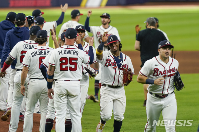 Atlanta Braves' Ronald Acuna Jr. (13) celebrates with teammates after Game 2 of a baseball National League Division Series against the Atlanta Braves Wednesday, Oct. 7, 2020, in Houston. The Braves won 2-0. (AP Photo/Eric Gay)