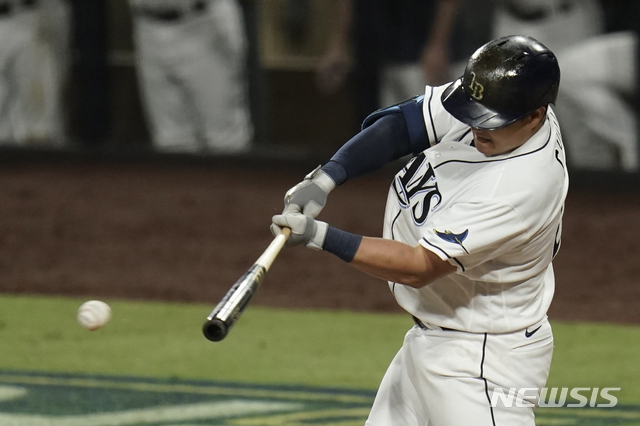 Tampa Bay Rays' Ji-Man Choi hits a single against the Houston Astros during the sixth inning in Game 7 of a baseball American League Championship Series, Saturday, Oct. 17, 2020, in San Diego. (AP Photo/Gregory Bull)