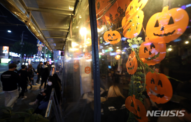 [서울=뉴시스]이윤청 기자 = 핼러윈 데이인 지난달 31일 서울 마포구 홍대거리의 한 헌팅포차 앞에 시민들이 입장을 위해 대기하고 있다. 2020.10.31. radiohead@newsis.com <사진은 기사내용과 관련 없습니다.>