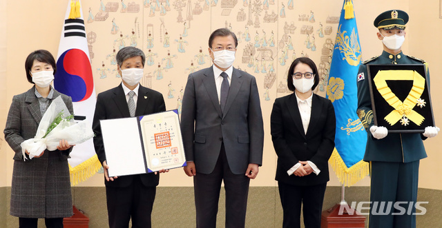 [서울=뉴시스]박영태 기자 = 문재인 대통령이 12일 청와대 본관에서 열린 전태일 열사 훈장 추서식에 참석해 전태일 열사의 유가족에게 무궁화장을 전달한 후 기념촬영을 하고 있다. 왼쪽부터 전태일 열사의 세째동생 전태리, 첫째동생 전태삼, 문재인 대통령, 둘째동생 전옥순. 2020.11.12. since1999@newsis.com