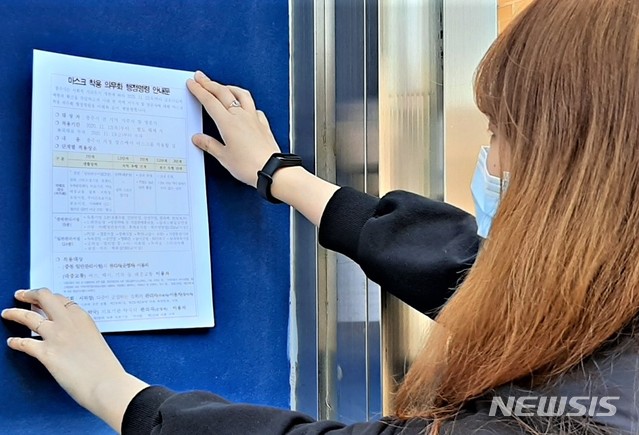 [충주=뉴시스]이병찬 기자 = 충북 충주시의 한 공무원이 13일 마스크 착용 의무화 행정명령 안내문을 게시하고 있다.2020.11.13.bclee@newsis.com