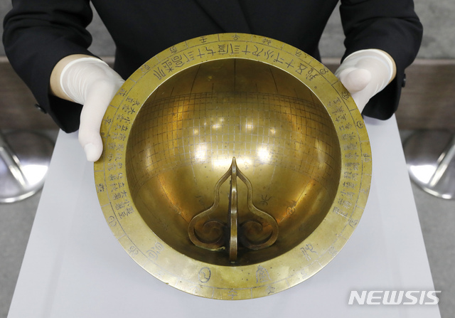 [서울=뉴시스] 고승민 기자 = 17일 서울 국립고궁박물관에서 문화재청 주최로 열린 '앙부일구' 언론공개회에서 관계자가 앙부일구를 공개하고 있다. 조선시대 과학문화의 발전과 애민정신을 엿볼 수 있는 앙부일구는 '하늘을 우러러 보는(앙) 가마솥(부) 모양에 비치는 해 그림자(일구)로 때를 아는 시계란 뜻이다. 앙부일구는 지난 상반기 미국의 한 경매에 출품됐으며, 문화재청이 이 정보를 입수해 국외소재문화재재단을 통해 매입했다. 2020.11.17.&nbsp; kkssmm99@newsis.com