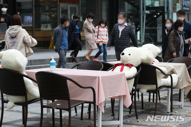 [서울=뉴시스] 고승민 기자 = 국내 코로나19 신규 확진자가 300여명에 이르는 것으로 집계된 18일 서울 무교동 일대에 다동무교동 타운매니지먼트 협의체가 설치한 사회적 거리두기 인형과 식탁이 놓여져 있다. 직장인들이 점심식사를 하러 식당으로 향하고 있다. 2020.11.18.kkssmm99@newsis.com