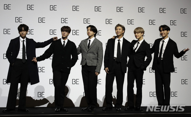 Members of South Korean K-pop band BTS pose for photographers during a press conference to introduce their new album "BE" in Seoul, South Korea, Friday, Nov. 20, 2020. K-pop band BTS has released their highly anticipated new album, which they describe as a “letter of hope.” The band held a socially distanced news conference in Seoul to unveil “BE,” its second album this year.  (AP Photo/Lee Jin-man)