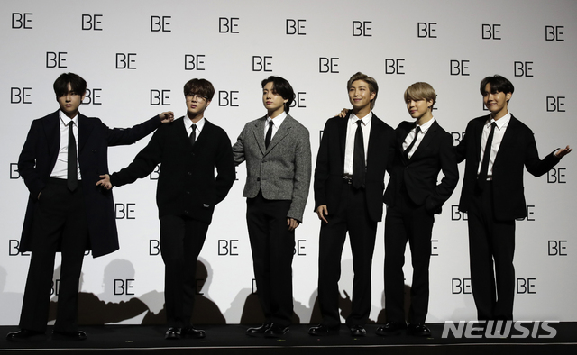 Members of South Korean K-pop band BTS pose for photographers during a press conference to introduce their new album "BE" in Seoul, South Korea, Friday, Nov. 20, 2020. K-pop band BTS has released their highly anticipated new album, which they describe as a “letter of hope.” The band held a socially distanced news conference in Seoul to unveil “BE,” its second album this year. (AP Photo/Lee Jin-man)