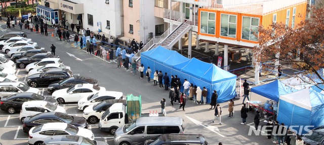 [서울=뉴시스]25일 서울 동작구청 광장에 마련된 워킹스루형 현장선별진료소를 찾은 시민들이 신종 코로나바이러스 감염증(코로나19) 검사를 받기 위해 길게 줄 서 있다. (사진=동작구 제공) 2020.11.25.&nbsp; photo@newsis.com
