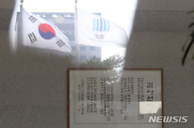 [서울=뉴시스] 이영환 기자 = 전국 6개 고등검찰청의 고검장과 그 아래 검사장, 중간간부, 평검사 등이 추미애 법무부 장관의 윤석열 검찰총장에 대한 징계 청구와 직무집행 정지 조치를 재고해달라는 집단 성명이 이어지고 있는 27일 오전 서울 서초구 서울중앙지검 로비의 검사선서 뒤로 검찰깃발과 태극기가 보이고 있다. 다만 검사장의 집단 성명 발표에 이성윤 중앙지검장 등 일부 검사장은 이름을 올리지 않았다. 2020.11.27. 20hwan@newsis.com