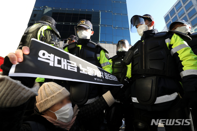 [서울=뉴시스] 이윤청 기자 = 서울시가 여의도 일대의 전국민주노동조합총연맹(민주노총)과 산별노조의 집회를 전면 금지한 지난 4일 서울 여의도 더불어민주당 중앙당사로 가는 길목에서 민주노총 소속 1인 시위자가 바닥에 앉아 항의하고 있다. 2020.12.04. radiohead@newsis.com