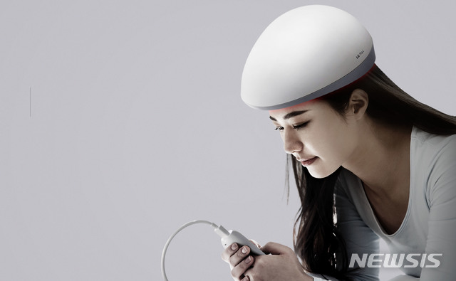 [서울=뉴시스] LG전자가 지난 10월 출시한 '프라엘 메디헤어'를 착용한 모습 (제공=LG전자) 