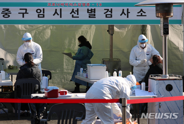 [서울=뉴시스] 고승민 기자 = 코로나19 신규 확진 환자가 926명으로 집계된 21일 서울역 중구임시선별진료소에서 의료진들이 검사 업무를 보고 있다. 2020.12.21. kkssmm99@newsis.com