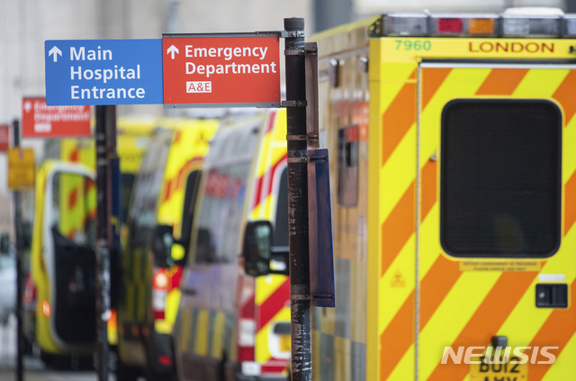 Ambulances outside the Royal London Hospital, in London, Tuesday Dec. 29, 2020. England Health Service figures show hospitals now have more Covid-19 patients than during April's first-wave peak, with fears of increased figures because of a Christmas social spread. (Dominic Lipinski/PA via AP)