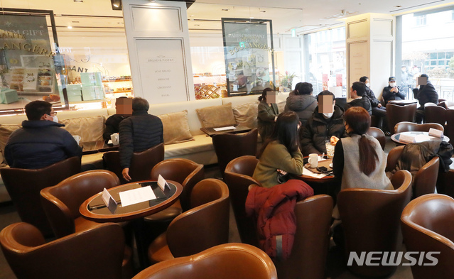[서울=뉴시스]배훈식 기자 = 카페, 헬스장, 노래방 등 다중이용시설에 대한 방역조치가 일부 완화된 18일 오후 서울 여의도의 한 카페에서 시민들이 자리에 앉아 음료를 마시고 있다. 2021.01.18. dahora83@newsis.com