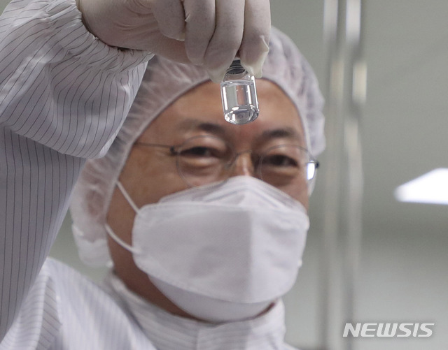 [안동=뉴시스]추상철 기자 =문재인 대통령이 20일 오전 경북 안동시 SK바이오사이언스 공장을 방문해 코로나19 백신 생산 시설을 시찰하던중 백신을 들어 보이고 있다. SK바이오사이언스 공장에서는 국민들의 코로나19 예방 접종을 위해 공급될 아스트라제네카 백신을 위탁생산하고 있다. 2021.01.20. scchoo@newsis.com