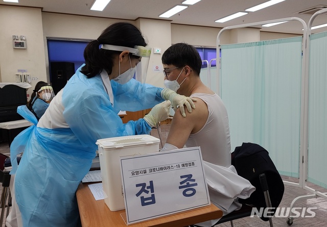 [대구=뉴시스]김정화 기자 = 코로나19 백신 접종이 시작된 26일 오전 대구 동구 진명고향마을에서 대구 동구 첫 접종자인 김석표(53) 원장이 아스트라제네카 백신 주사를 맞고 있다. 2021.02.26. jungk@newsis.com