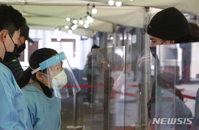 [서울=뉴시스]김명원 기자 = 27일 서울 중구 서울역 신종 코로나바이러스 감염증(코로나19) 임시검사소에서 의료진이 검사를 받기위해 온 외국인과 검사를 진행 상담을 하고 있다.  2021.02.27. kmx1105@newsis.com