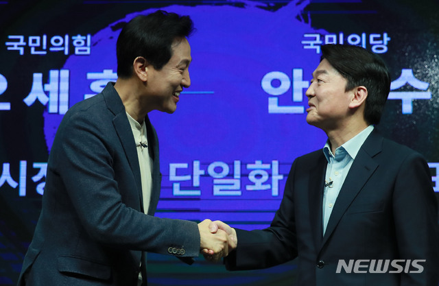 [서울=뉴시스]국회사진기자단 = 오세훈 국민의힘 서울시장 후보와 안철수 국민의당 서울시장 후보가 15일 오후 서울 영등포구 더플러스 스튜디오에서 열린 단일화 비전발표회를 마친 후 악수하고 있다.  2021.03.15. photo@newsis.com