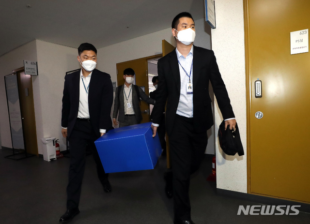 [세종=뉴시스]강종민 기자 = 전해철 행정안전부 장관 전 보좌관 가족의 부동산 투기 의혹을 수사중인 경찰이 29일 오후 정부세종청사 국토교통부 공공주택추진단에 대한 압수수색을 마친 뒤 압수품을 들고 차량으로 이동하고 있다. 2021.03.29. ppkjm@newsis.com