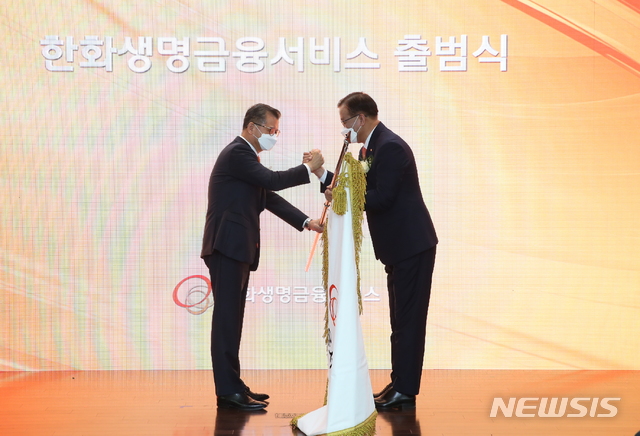 [서울=뉴시스] 한화생명의 판매전문 자회사 한화생명금융서비스㈜가 1일 정식 출범했다. 63한화생명빌딩 별관 1층 세미나실에서 열린 한화생명금융서비스 출범식에서 한화생명 여승주 대표이사 사장(사진 왼쪽)이 한화생명금융서비스 구도교 대표이사(사진 오른쪽)에게 사기를 전달하고 있다. (사진=한화생명 제공) 2021.04.01. photo@newsis.com *재판매 및 DB 금지
