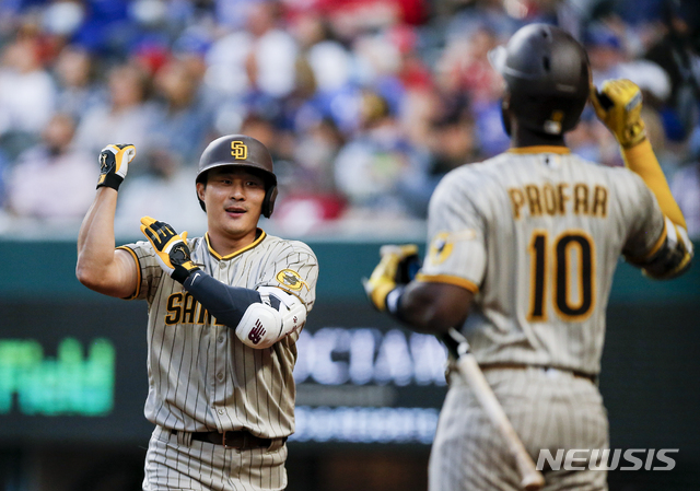 San Diego Padres' Ha-Seong Kim, right, is congratulated by Jurickson Profar (10) after hitting a solo home run during the fifth inning of a baseball game against the Texas Rangers, Saturday, April 10, 2021, in Arlington, Texas. (AP Photo/Brandon Wade)