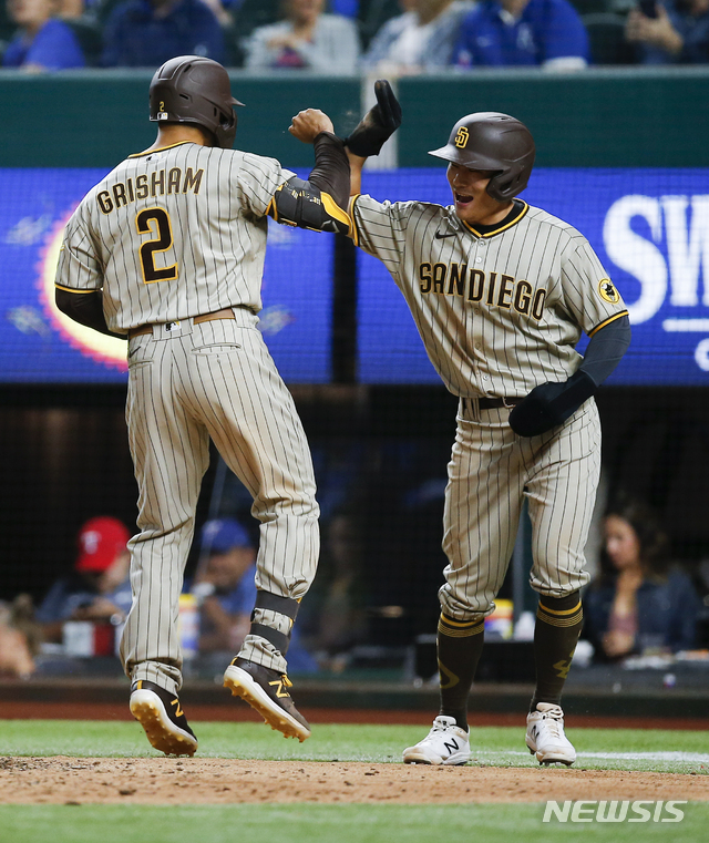 San Diego Padres' Trent Grisham (2) is congratulated by Ha-Seong Kim after hitting a two-run home run during the seventh inning of a baseball game against the Texas Rangers, Saturday, April 10, 2021, in Arlington, Texas. (AP Photo/Brandon Wade)