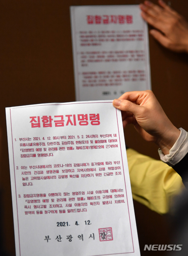 [부산=뉴시스] 하경민 기자 = 부산지역 유흥시설 집합금지 조치 첫날인 12일 오후 부산진구청 공무원들이 서면의 한 업소 출입구에 집합금지 행정명령문을 부착하고 있다. 부산시는 지난 2일부터 적용 중인 사회적 거리두기 2단계를 12일부터 5월 2일까지 3주간 연장하고, 특히 이 기간 유흥시설 5종과 홀덤펍에 대해서는 집합금지 명령을 내렸다. 2021.04.12. yulnetphoto@newsis.com