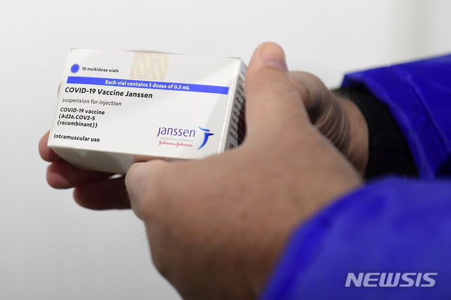 A box of Janssen vaccines is shown by pharmacist Zsolt Szenasi at a warehouse of Hungaropharma, a Hungarian pharmaceutical wholesale company, in Budapest, Hungary, after the arrival of the first batch of the Johnson & Johnson, US, made one-dose vaccine against the new coronavirus in the country Tuesday, April 13, 2021. The first shopment contains 28 thousand doses of Janssen. (Szilard Koszticsak/MTI via AP)