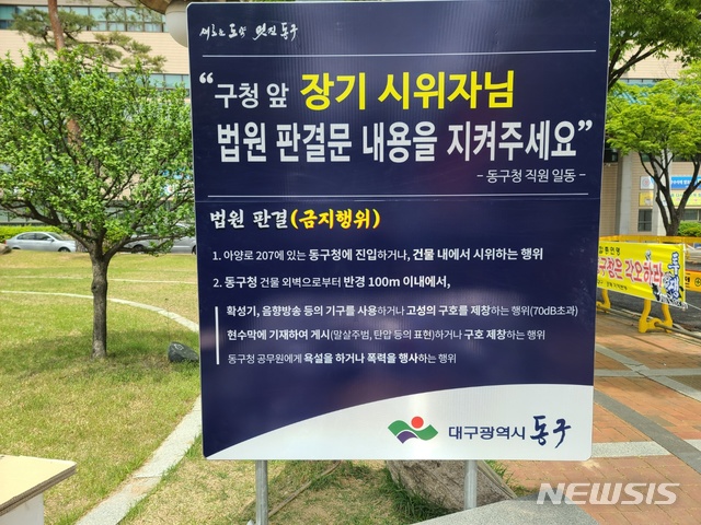 [대구=뉴시스]김정화 기자 = 대구 동구청 앞 10개월째 계속되는 야외 농성 집회가 끝내 민·형사 법적 다툼까지 번진 것으로 나타났다. 사진은 동구청이 설치한 안내판. 2021.04.23. jungk@newsis.com