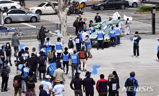 [부산=뉴시스]하경민 기자 = '남북철도 잇기 한반도 평화 대행진 추진위원회'가 27일 오전 부산 동구 부산역 광장에서 남북철도 잇기를 형상화한 상징조형물과 함께 보도행진 첫 발을 내딛고 있다. 추진위는 이날 부산역을 출발해 휴전협정 체결일인 7월 27일까지 90일 동안 남북철도가 끊어진 장소인 임진각까지 550㎞ 가량 대행진을 펼칠 계획이다. 2021.04.27. yulnetphoto@newsis.com