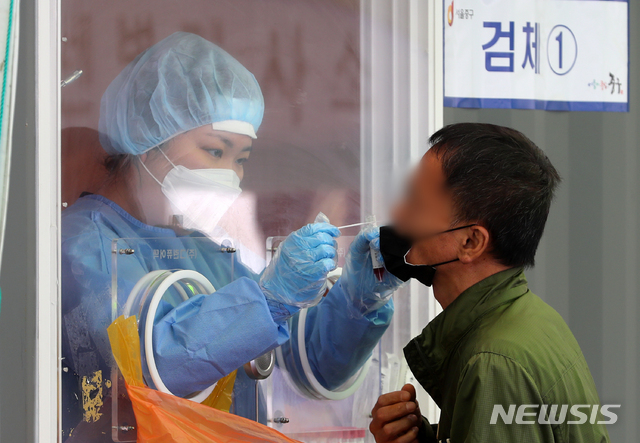 [서울=뉴시스]배훈식 기자 = 0시 기준 코로나19 신규 확진자 수가 606명을 기록한 2일 오전 서울 중구 서울역광장에 마련된 코로나19 중구 임시선별검사소에서 한 시민이 검사를 받고 있다. 2021.05.02. dahora83@newsis.com