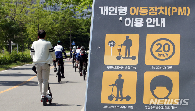 [서울=뉴시스]김병문 기자 = 헬멧 의무 착용 등 전동킥보드 이용조항 위반에 대한 범칙금 부과 강화를 하루 앞둔 지난 12일 오후 서울 여의도 한강공원에서 시민이 전동킥보드를 타고 있다. 2021.05.12. dadazon@newsis.com