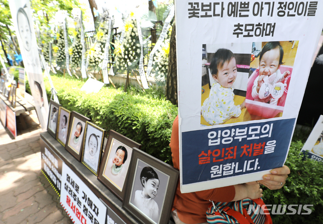 [서울=뉴시스]정병혁 기자 = '정인이'의 양부모의 1심 선고 공판이 열린 14일 오후 서울 양천구 서울남부지방법원 입구에서 시민들이 강력한 처벌을 촉구하는 피켓을 들고 있다. 2021.05.14. jhope@newsis.com