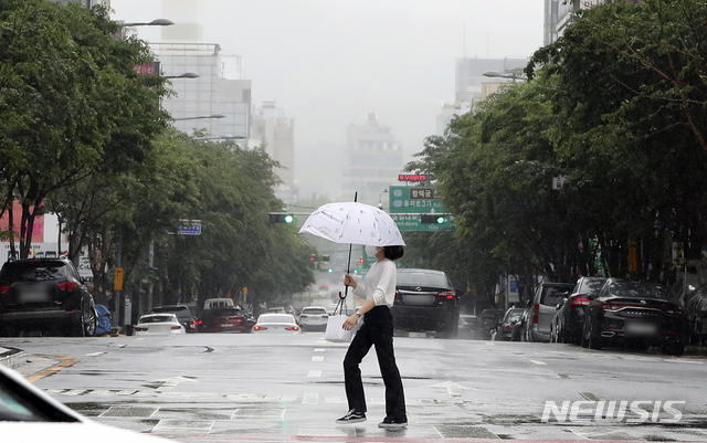 [서울=뉴시스]최진석 기자 = 주말 동안 전국에 비가 내리고 있는 16일 오전 서울 중구 남산골한옥마을 인근에서 사람이 우산을 쓴채 발걸음을 재촉하고 있다. 2021.05.16. myjs@newsis.com